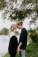 Young Romantic Couple Holding Each Other for Couples Portraits by the Pond Outside in Nature