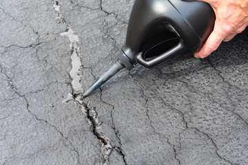 Repairing a crack in asphalt driveway