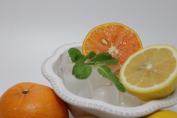 Orange , Lemon and Mint Leaves on White background Citrus Fruits full with Vitamin C, delicious and Refreshing, good for  health, valued as part of a nutritious and tasty diet