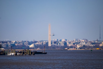 Airplane flying into airport near the DC monuments