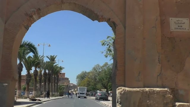 Car front window view approaching and driving  through an old Taroudant city fortification wall triple arched Bab Selsla, Bab el-Kasbah or Bab Essalsla gate into the kasbah