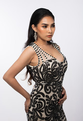 Fototapeta premium Portrait of Miss Pageant Beauty Contest in Asian Evening Ball Gown black lace dress without Silver Diamond Crown Sash, fashion make up hair style, studio lighting white background isolated copy space