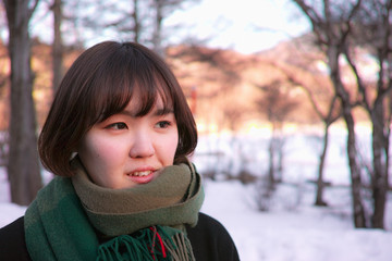 A pretty Japanese lady posing in front of Winter scenery