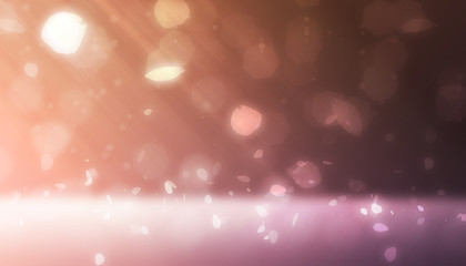 Pink and orange light scene with petal light and bokeh falling from side scene on dark background