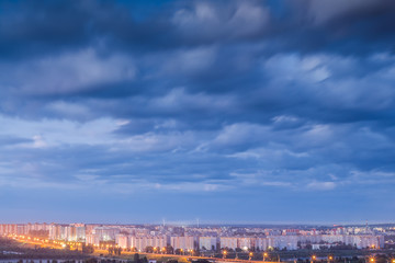 Obraz premium Terrible cloudy sky at night over the city. Gray rainy clouds. A storm warning.