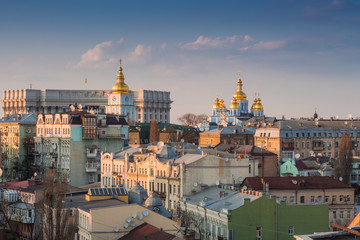 Golden dome with a cross on the tower. Church in Kiev at sunset. Temple in the city at sunset.