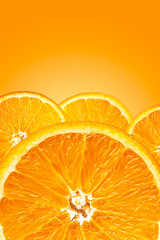 Background of half cut oranges on orange background
