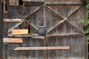 Fototapeta na wymiar old derelict cracked farm barn wooden door