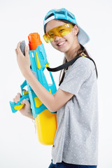 Happy beauty Asian girl holding plastic water gun at Songkran festival, Thailand. Isolated on white background