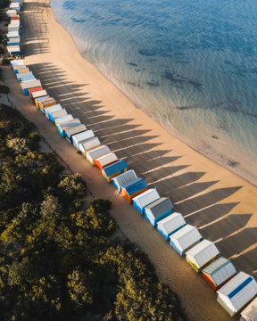 Aerial shadows cast across the beach with the Brighton Bathing Boxes in Melbourne