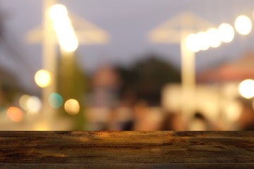 Empty dark wooden table in front of abstract blurred bokeh background of restaurant . can be used for display or montage your products.Mock up for space.