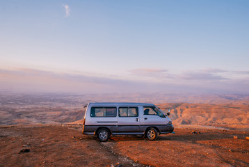 Bus in the desert of Jordan on sunset.