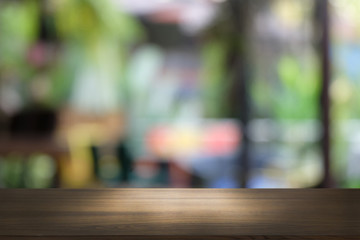Empty dark wooden table in front of abstract blurred bokeh background of restaurant . can be used for display or montage your products.Mock up for space.