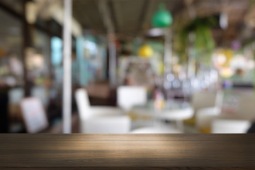 Empty dark wooden table in front of abstract blurred bokeh background of restaurant . can be used for display or montage your products.Mock up for space.