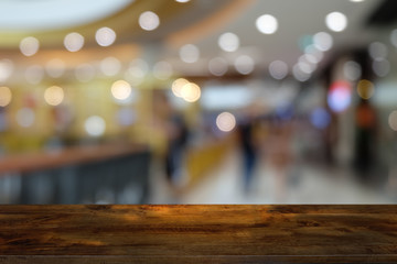 Empty dark wooden table in front of abstract blurred bokeh background of restaurant . can be used for display or montage your products.Mock up for space.