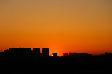 Fototapeta na wymiar Silhouette of urban landscape at the sunrise