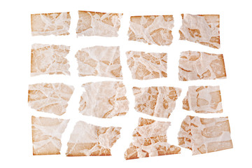 Torn sheets of brown aged paper on white background isolated close up, ragged shreds of old paper...