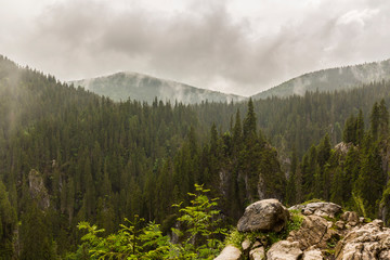 Mountain scenery in the Transylvanian Alps in summer, with mist and rain clouds