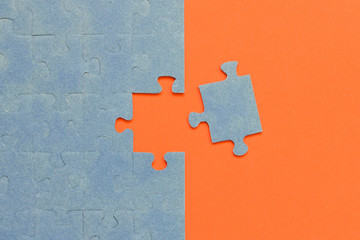Abstract background of many puzzles on an orange background. The concept of teamwork.