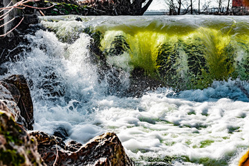 Artificial waterfall in germany. With colorfull glowings through the sunlight.