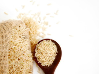 organic rice in sack or in spoon isolate on white background,topview,copy space