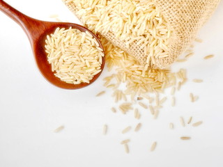 organic rice in sack or in spoon isolate on white background,topview,copy space