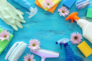 Spring cleaning concept with supplies over blue wooden background. Top view, flat lay