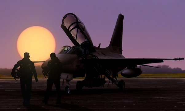 Air force jet fighter pilots silhoutte at dusk sunset on military base airfield
