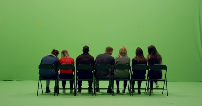 GREEN SCREEN CHROMA KEY Back view group of young people watching and cheering at a sport event. 4K UHD ProRes 4444