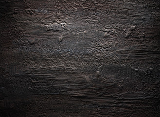 Grungy dark stucco wall with spotlight