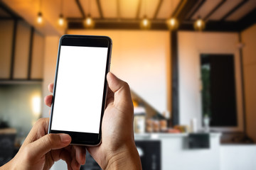 A woman hand holding smart phone device in the coffee shop or cafe background.
