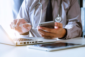 Medical technology concept. Doctor working with mobile phone and stethoscope and digital tablet...