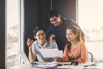 Businesspeople discuss a project ;A woman sitting at the computer shows infographics to partners; An example of good relations at work.