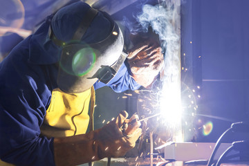Man welding in workshop. Arc welding.