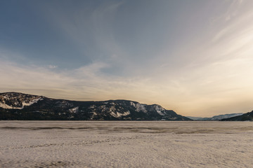 Sunset landscape of frozen Little Shuswap Lake British Columbia Canada.