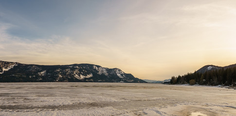 Early spring evening landscape of frozen Little Shuswap Lake British Columbia Canada.