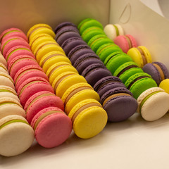 Many beautiful colored macarons in the box