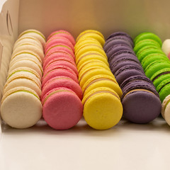 Many beautiful colored macarons in the box