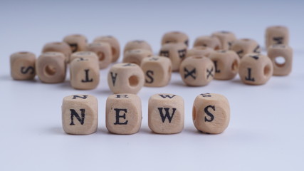 NEWS inscription on wooden alphabet over white background with selective focus