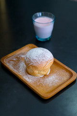 plain butter bread with icing sugar powder on wooden plate