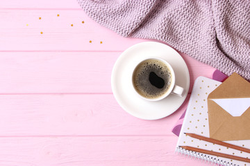 cup of coffee with crema and stationery on wooden background top view.
