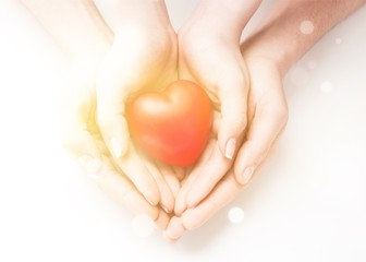 Man and woman holding red heart in hands isolated
