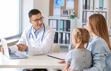 Little girl with mother at pediatrician's office