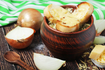 A ceramic pot with French onion soup