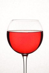 Bright red cocktail against white background