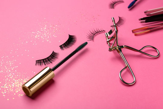 Mascara With False Eyelashes And Tools On Color Background