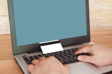 Hand Typing On Laptop Keyboard With Credit Card, Online Shopping Concept .