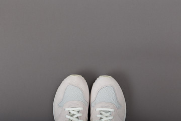 Overhead Shot Of White Sneakers On colored Background