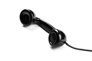 old vintage phone handset hanging by the chord isolated over a white background