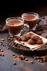 Composition with truffles candy and cocoa mug on wooden board
